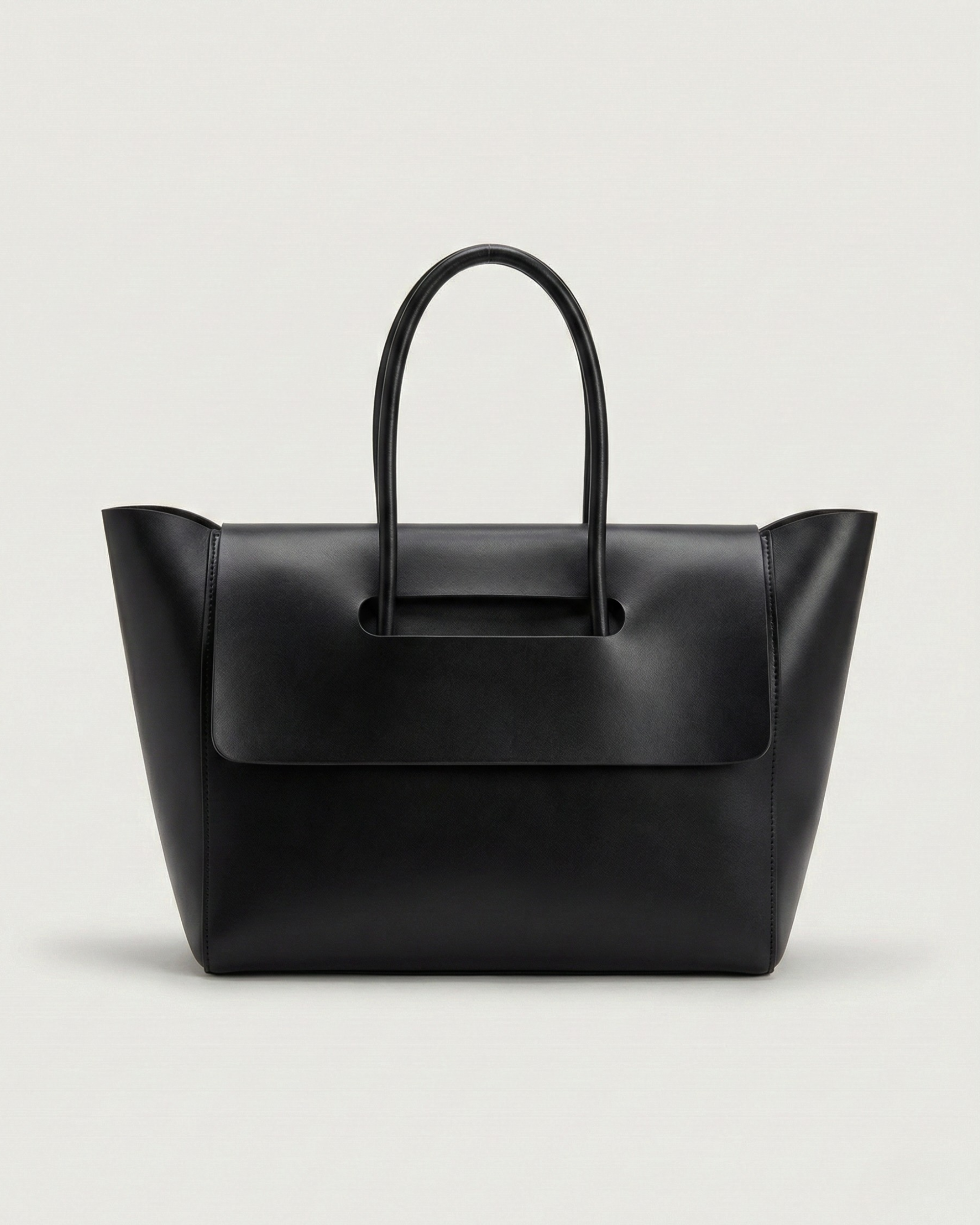 Black leather tote bag on a light gray background