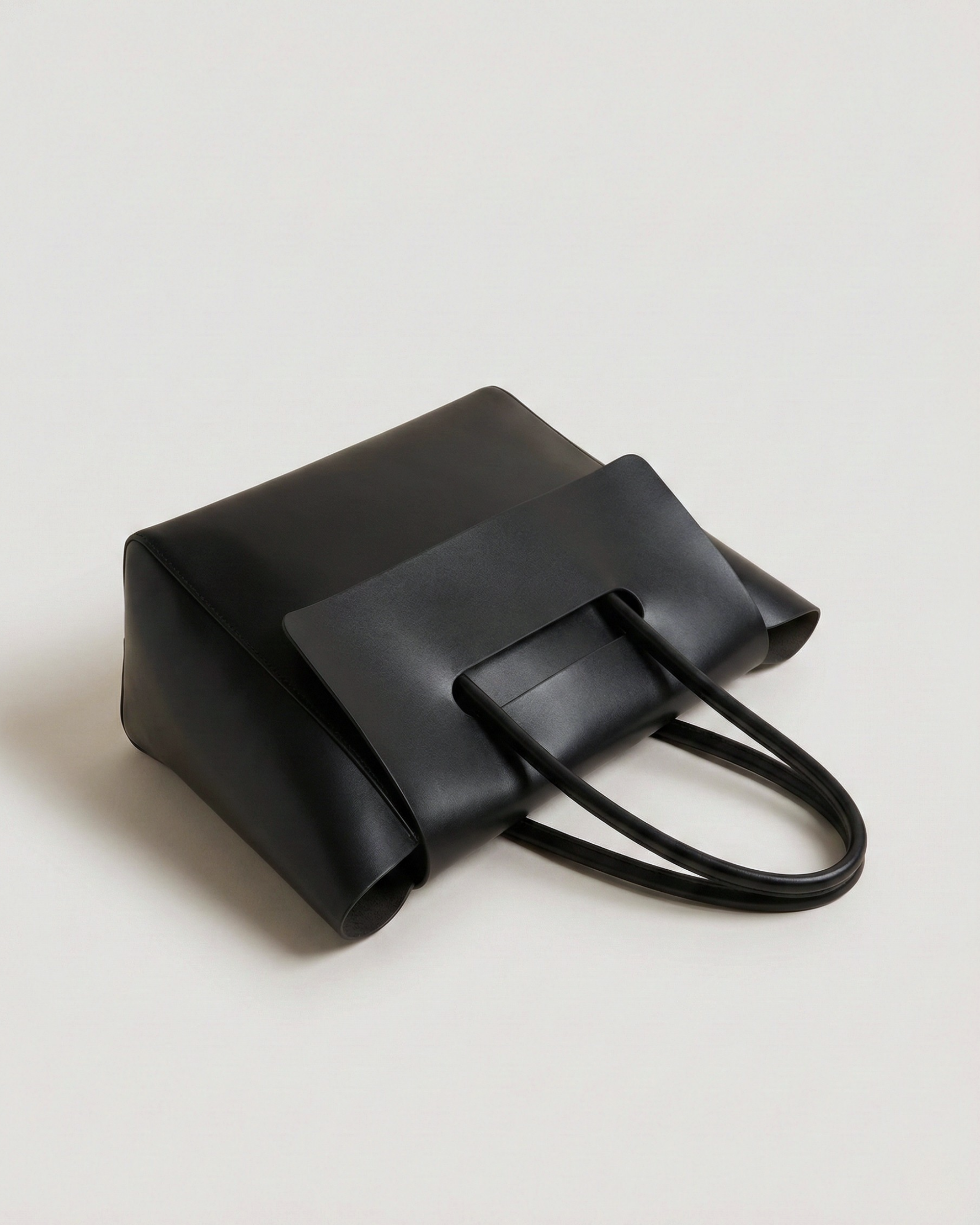 Black handbag on a light gray background
